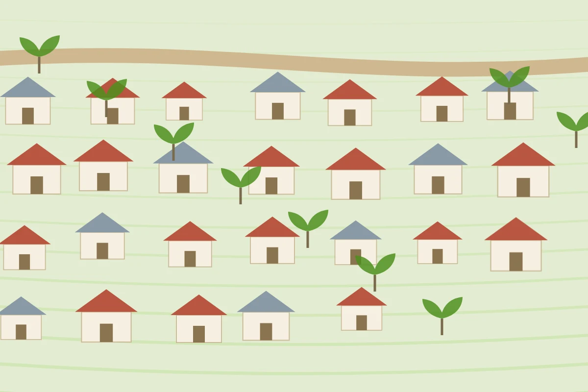 A village of tin-roofed houses between paddy fields and a river